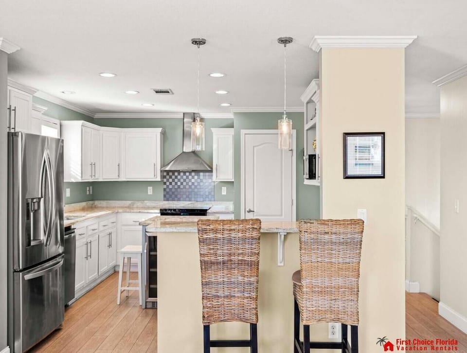 Modern kitchen with sleek appliances and cozy breakfast bar seating