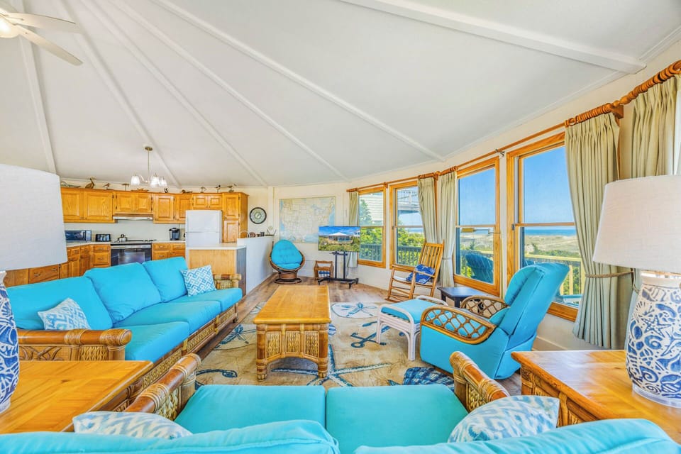 Sink into plush turquoise seating while the ocean breeze fills your bright, open living space with natural light and stunning coastal views stretching to the horizon.