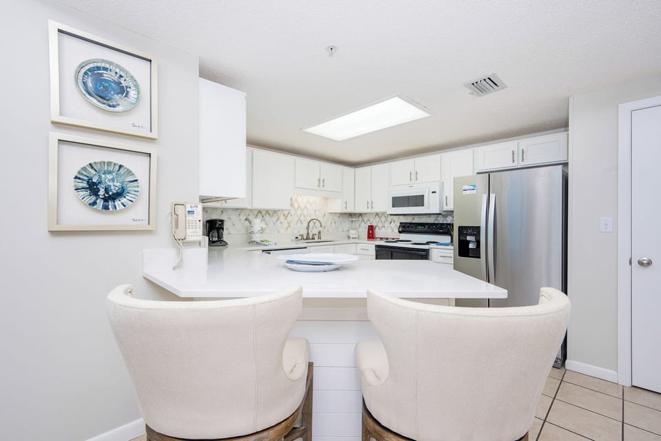 Enjoy casual meals at the sleek breakfast bar, surrounded by stylish decor and a welcoming atmosphere