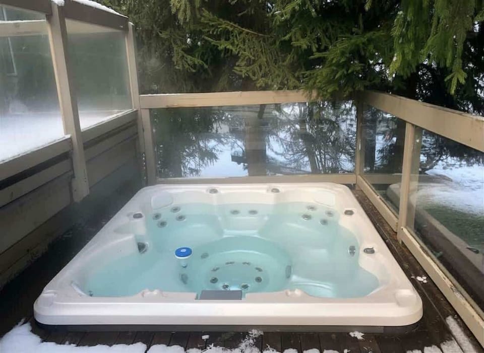 - Private outdoor hot tub with forest views and fresh air  
- Relax under the trees after a day on Whistler slopes  
- Luxury chalet stay with bubbling spa and winter warmth  