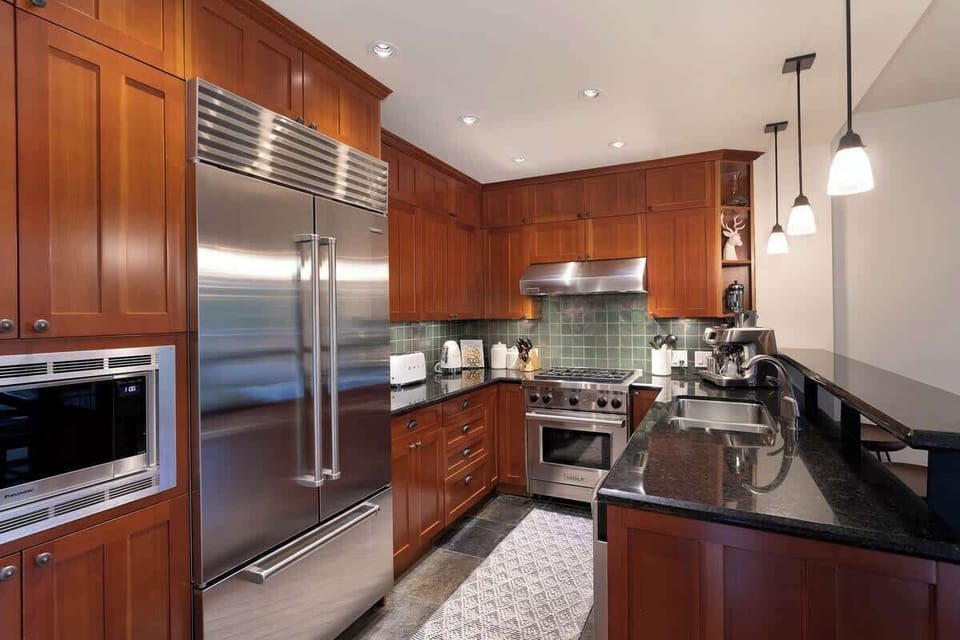 - Gourmet kitchen with stainless appliances and gas range  
- Rich wood cabinetry and granite counters for a sleek look  
- Fully stocked for cooking hearty post-ski meals  
