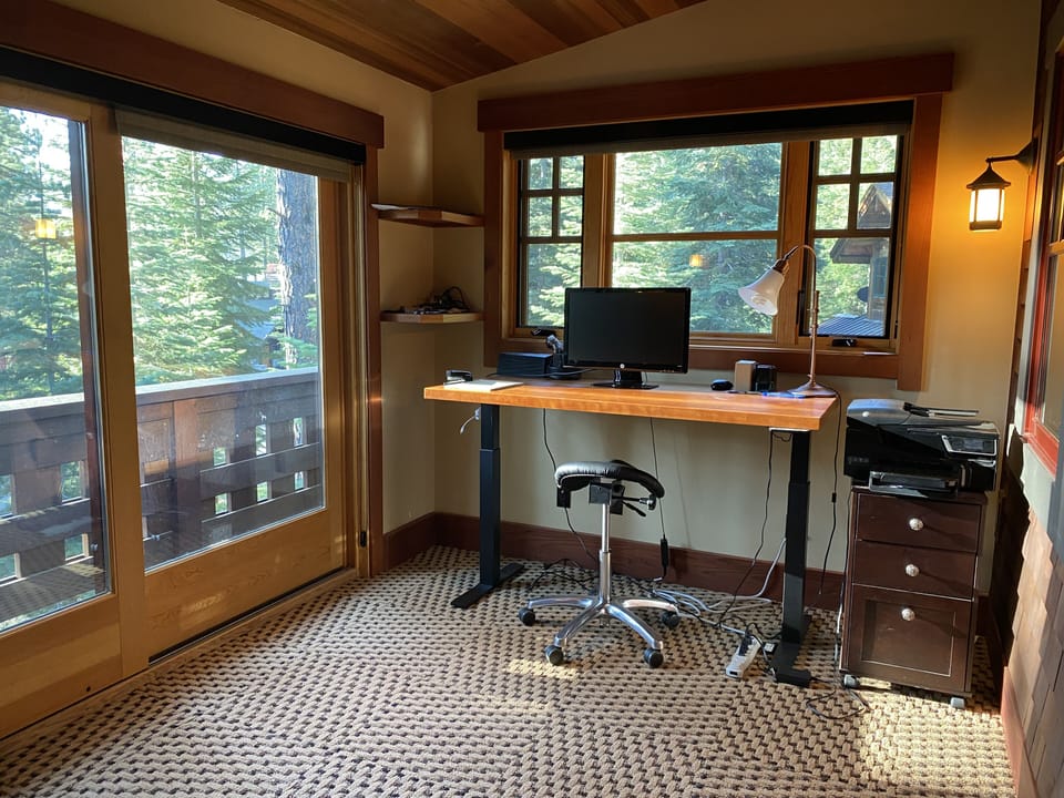 Upstairs office with adjustable stand/sit desk, extra monitor, printer.