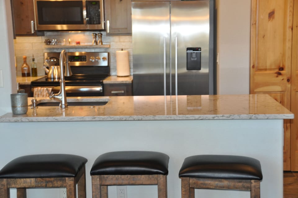 Quartz countertop bar with additional seating for 3