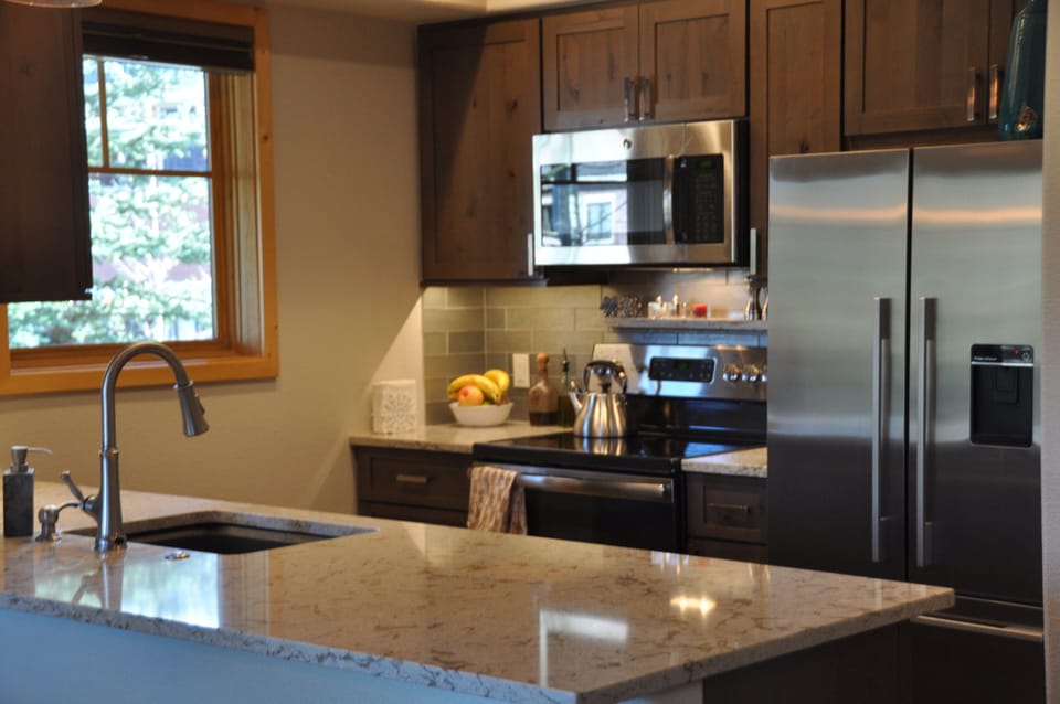 Bright kitchen with updated cabinets and stainless appliances, quartz counters.