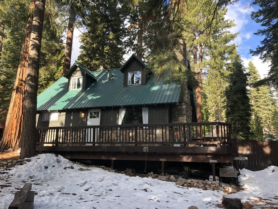 Front view with front and side decks and fenced backyard