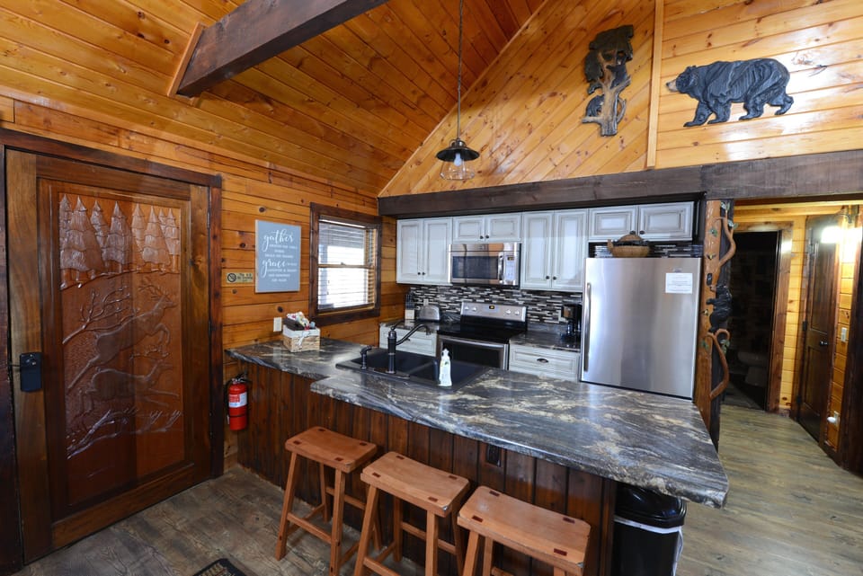 Kitchen with snack bar area. Hallway to main level bedrooms & bath on the right