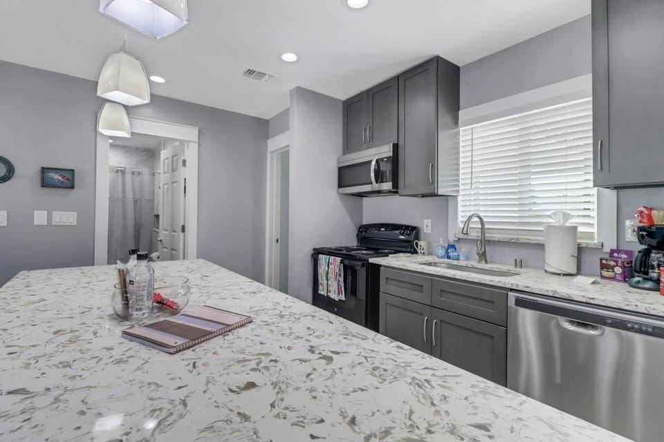 The kitchen is elegantly appointed, granite counters, new appliances and cabinetry