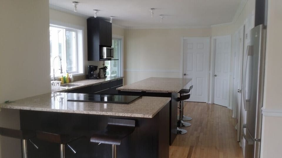 Top Floor - Fully Equipped Kitchen, large island with seating stools. 