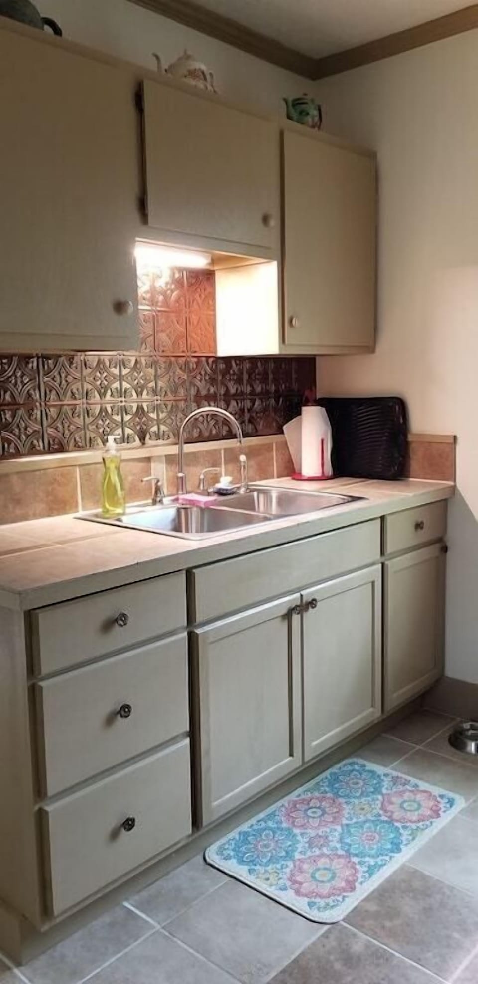 Kitchen sink and counter. Table service for 4 people is provided