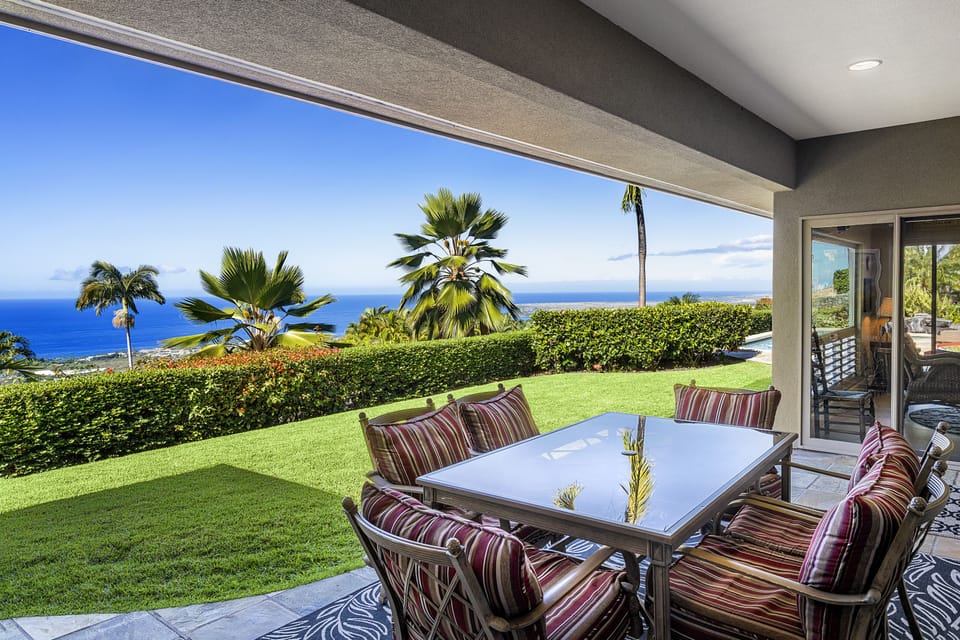 Al fresco dining on the lanai, with stunning views of the coastline and Pacific Ocean.