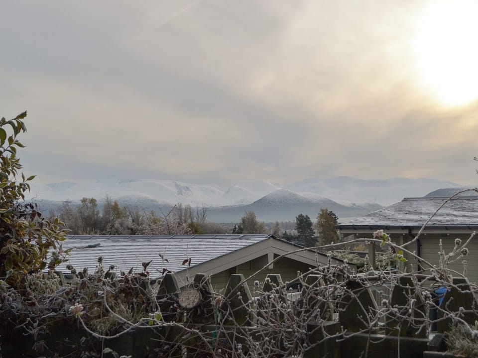 Stunning views towards the mountains from the garden | Rowan Cottage, Aviemore