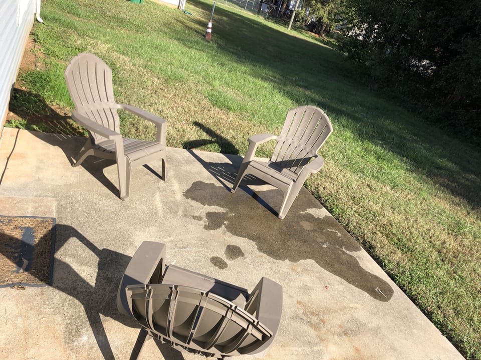large backyard with a convenient patio sitting area.
