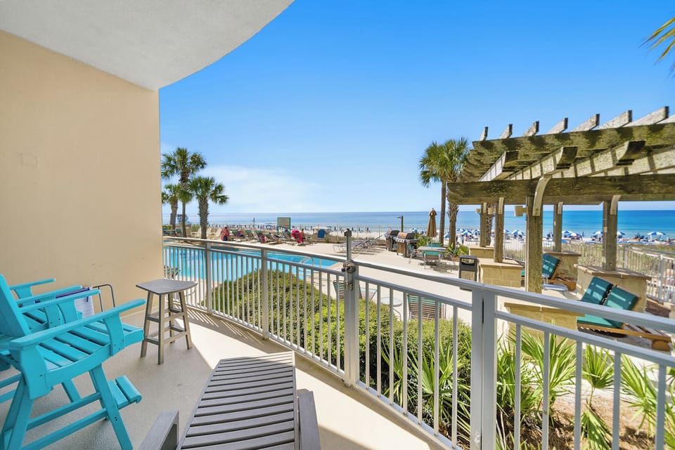 Step onto your private balcony and soak in stunning ocean views, turquoise pool, and swaying palms—your perfect coastal retreat awaits.