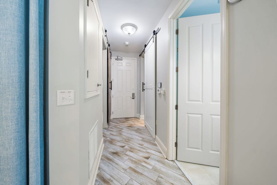 Step into your bright, welcoming hallway with beautiful wood-style floors guiding you to your comfortable rooms.
