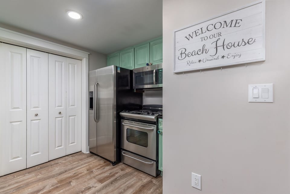 Stocked kitchen with upgraded dishes and full sized fridge. Microwave/stove/oven