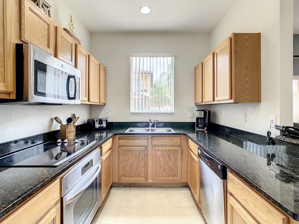 Bright and spacious kitchen with natural light and all essentials provided.