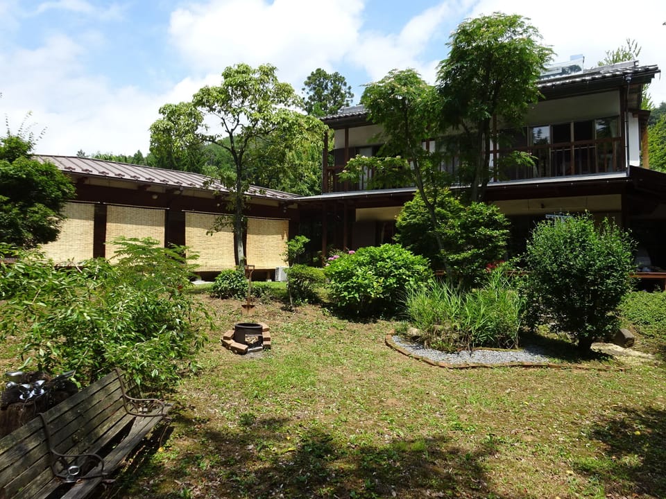 Garden in high sumer with sunscreens in the guest section.