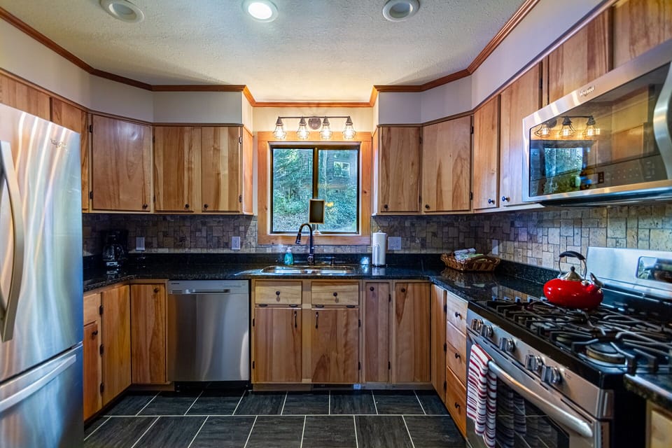 Clean remodeled kitchen with granit countertops and gas range, microwave oven and dishwasher. 