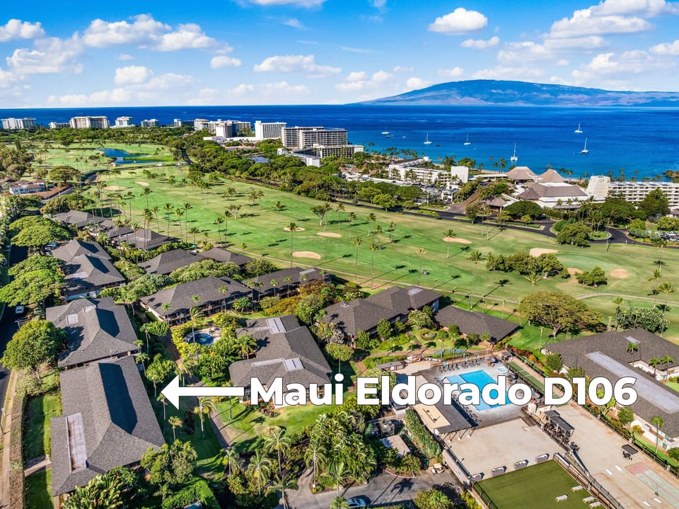 Aerial view of Maui Eldorado framed by lush golf course greens and shimmering ocean views
