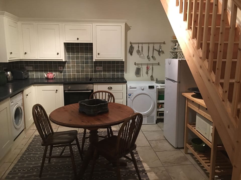 This well equipped kitchen has a microwave and a washing machine