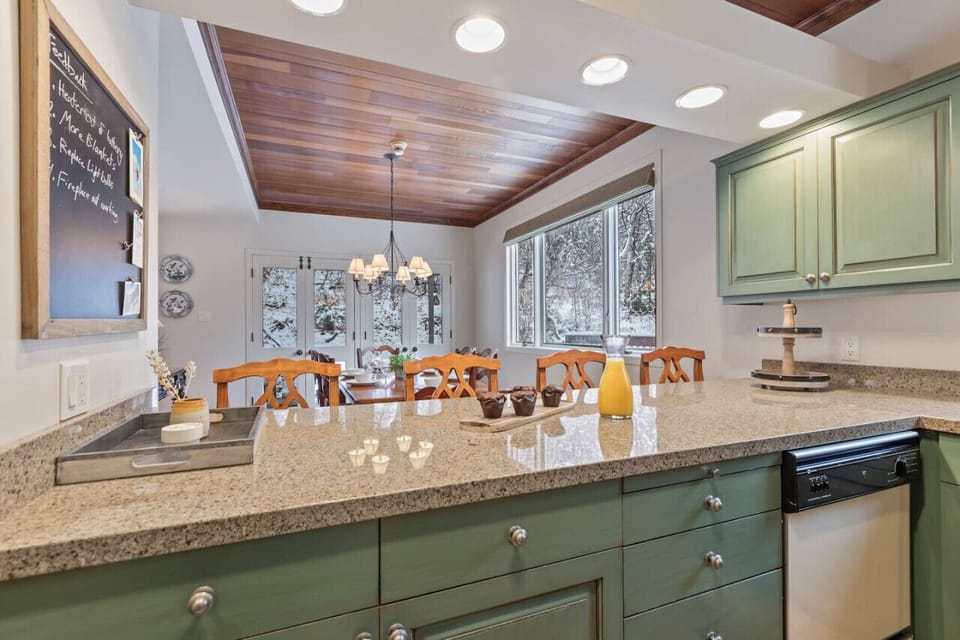 The kitchen and dining areas flow seamlessly into the living space, creating a wide-open layout ideal for entertaining
