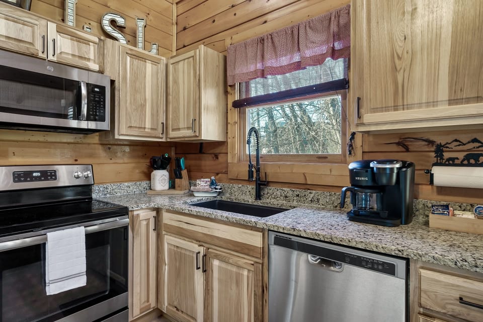 Fully stocked kitchen w/ Keruig and Coffee pot. Pots, pans, crockpot, dishes, etc.