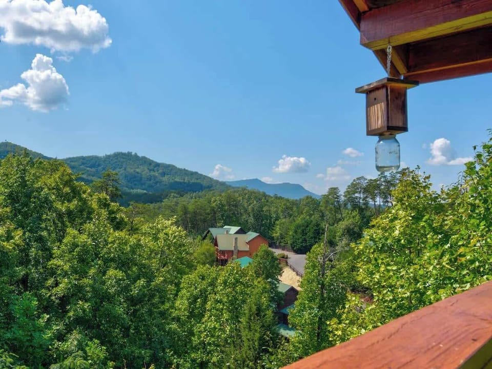  As you gaze out over the treetops from the quietude of the covered deck, you could easily forget that our cabin is less than a mile from the attractions of the Pigeon Forge Parkway.