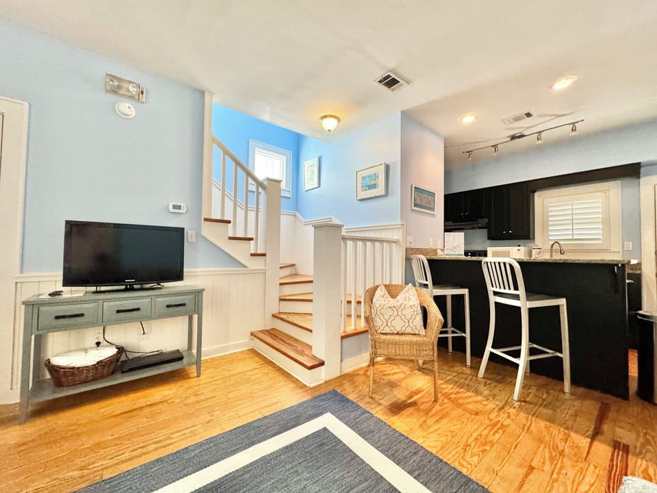 LIVING ON FIRST LEVEL WITH FLATSCREEN, NEXT TO KITCHEN