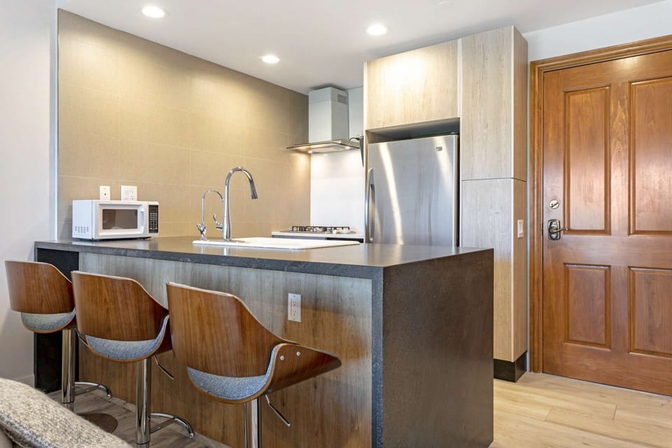 The newly renovated kitchen features a gas range, stainless steel appliances, microwave, drip coffee maker, and more!