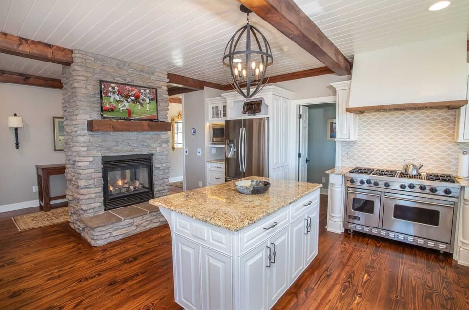 Kitchen with Stacked Stone Fireplace and Flat Screen TV
