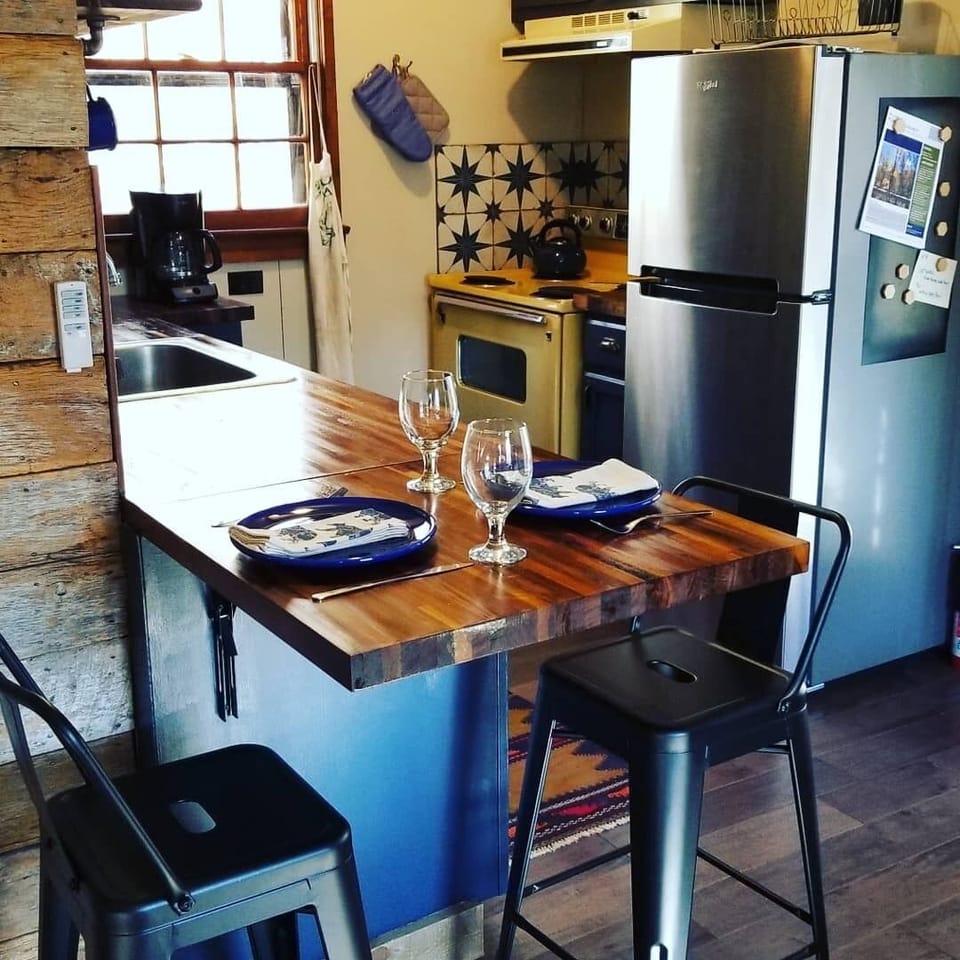 Newly refreshed kitchen with butcher block countertops and dinning spot for two.