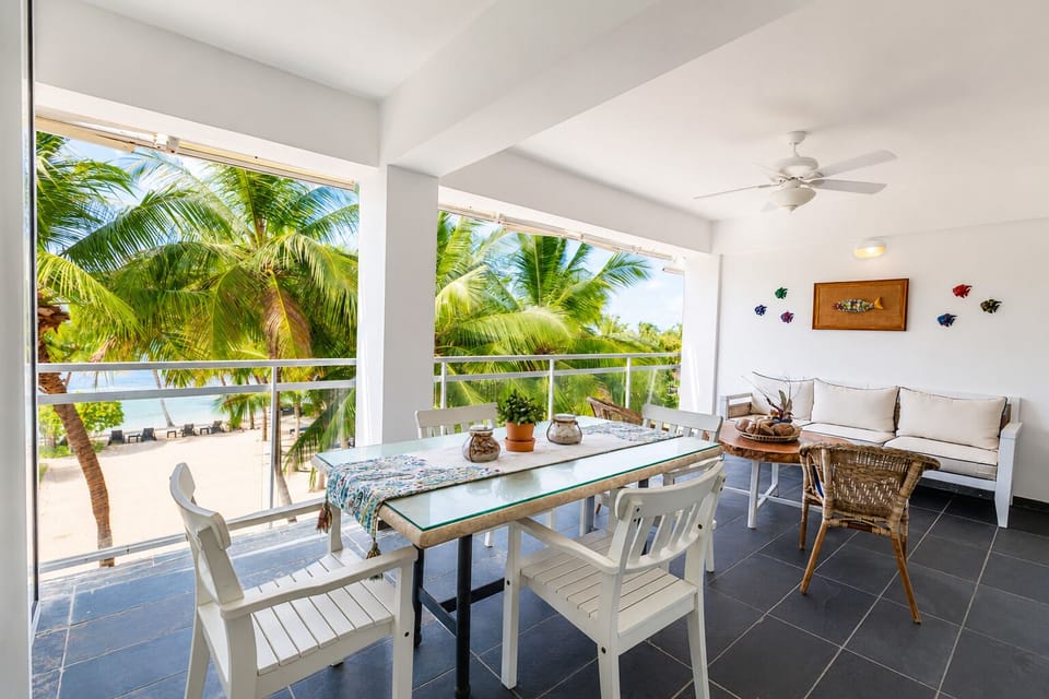 Balcony Retreat: Enjoy meals with ocean views amidst swaying palm trees and tropical decor!