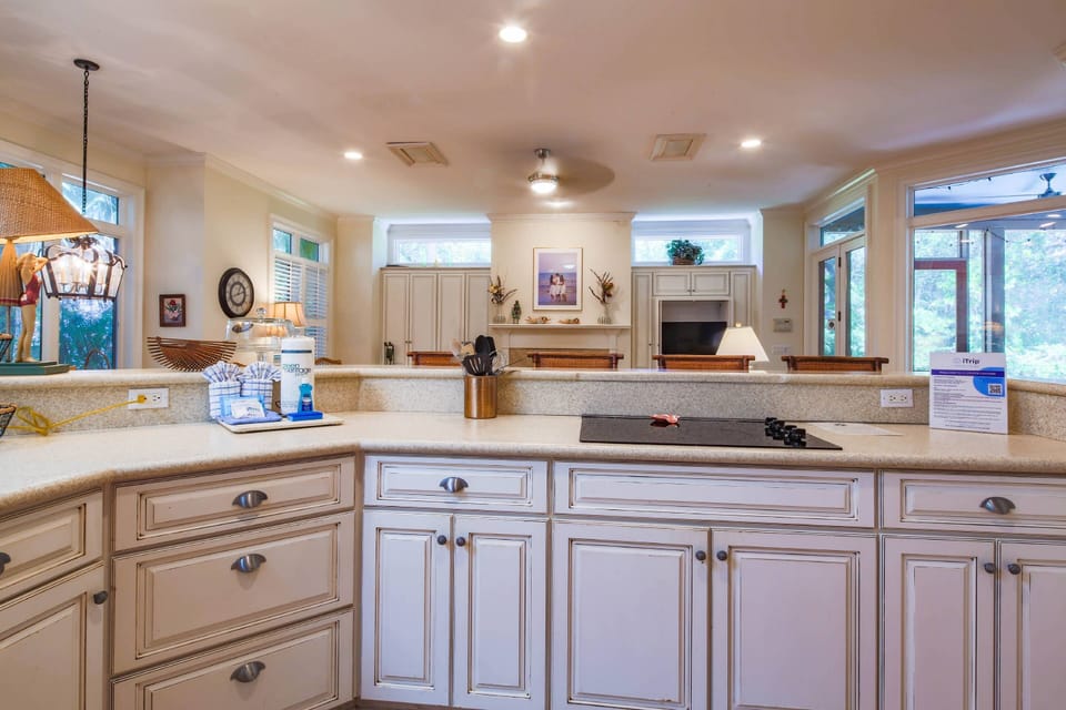 The open floor plan layout between the kitchen and den make it easy to interact with your guests.