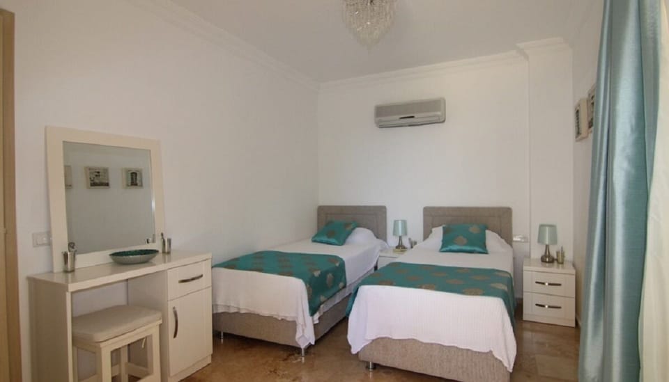 Twin bedroom with wardrobe, and door leading to private dining area and poolside