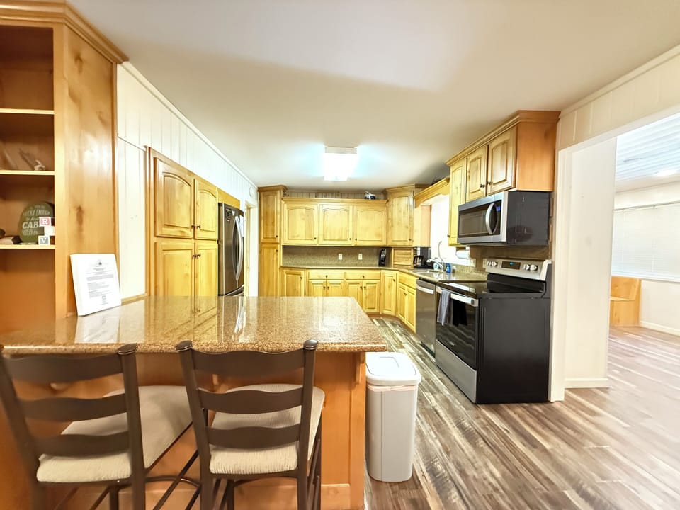 A kitchen in a cabin exudes warmth and practicality, designed for both comfort and functionality.