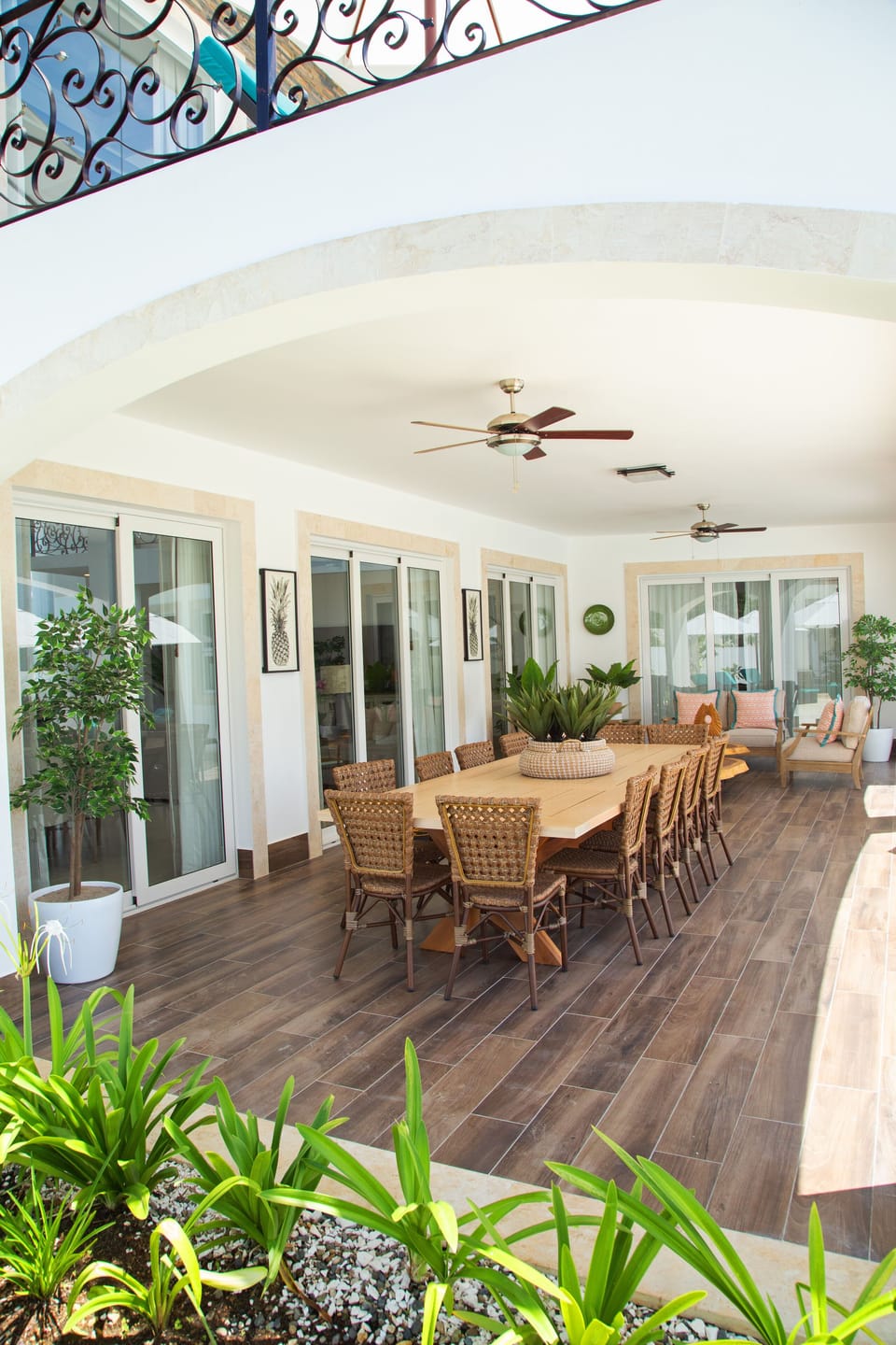 Outdoor covered terrace area with seating and dining room table for 12.