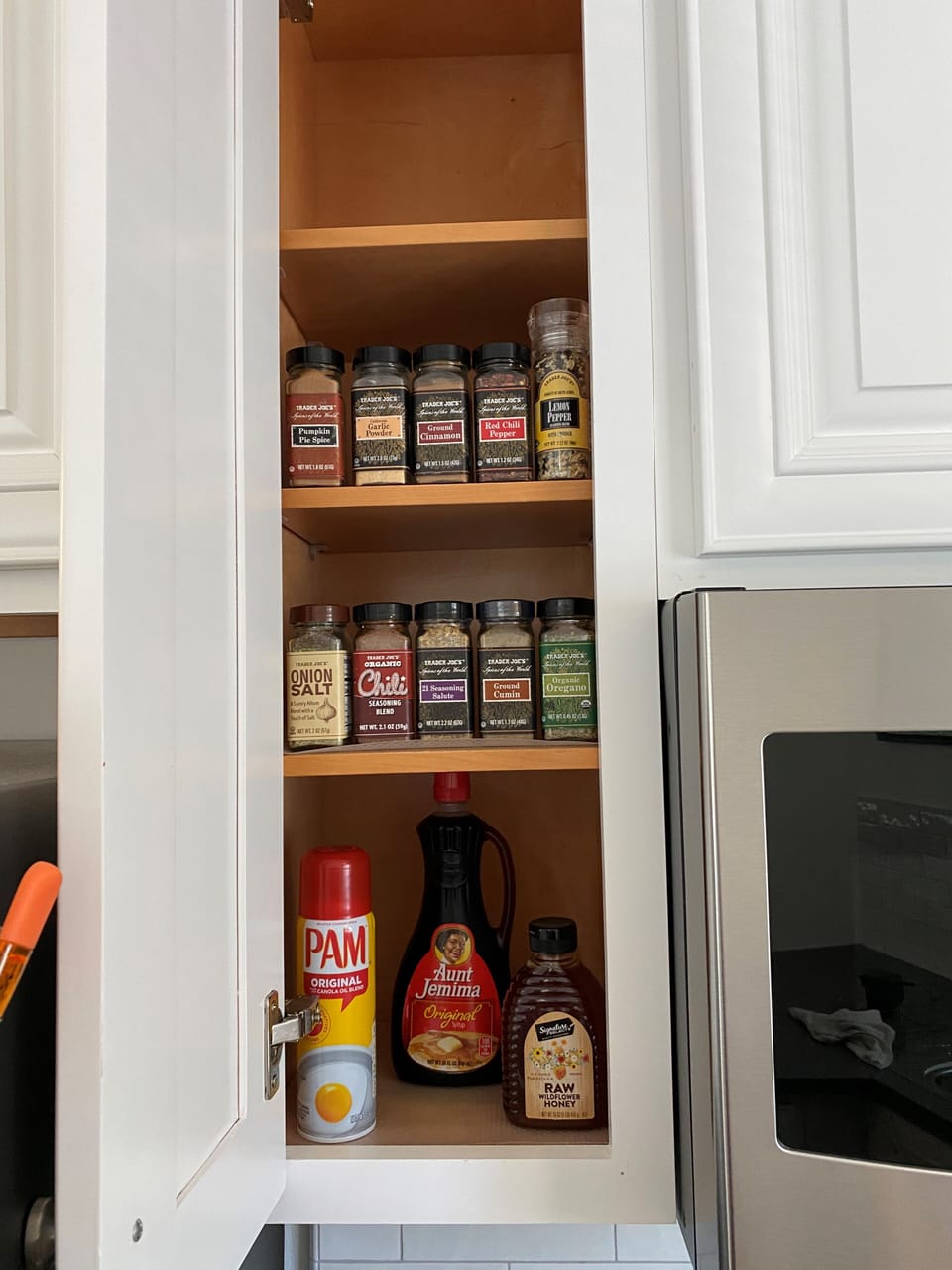 Kitchen is stocked with various seasonings, olive oil and vinegar.