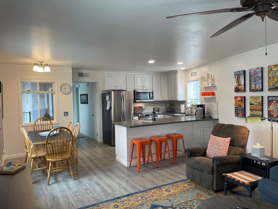 Dining table seats 6 with additional 3 barstools at counter.