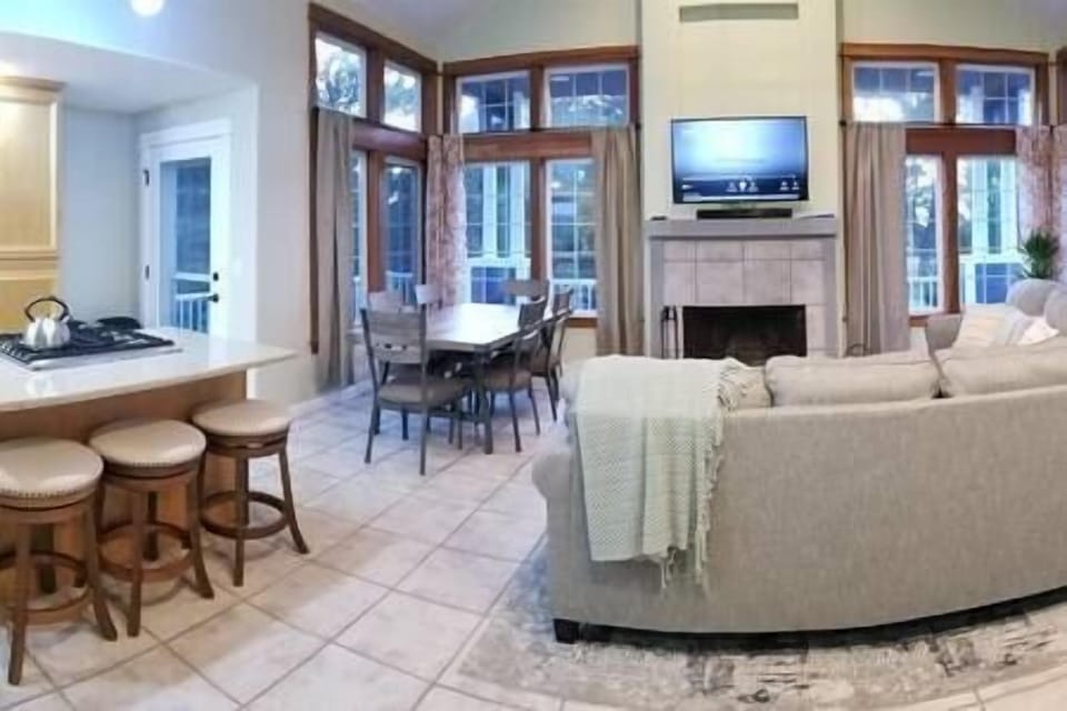 This house offers a beautiful open space with large, fully stocked kitchen, dining table for 6, island for 3 and coffee/wine/breakfast bar that seats 4.  There is a 3 seat (queen) sleeper sofa and 2 person loveseat, Hulu TV and 5G internet service.  