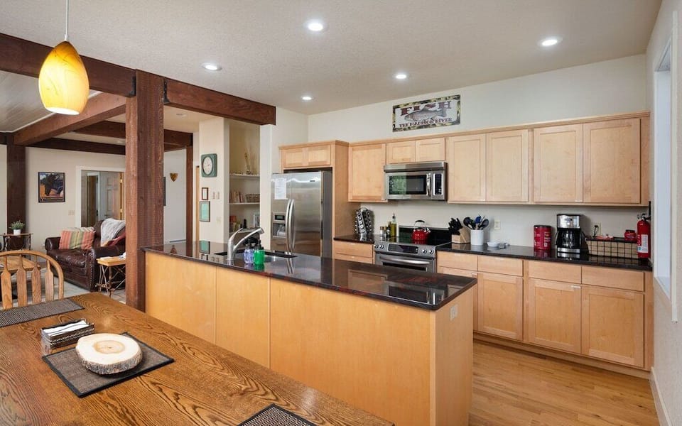 The well equipped kitchen has stainless steel appliances & granite counter tops.