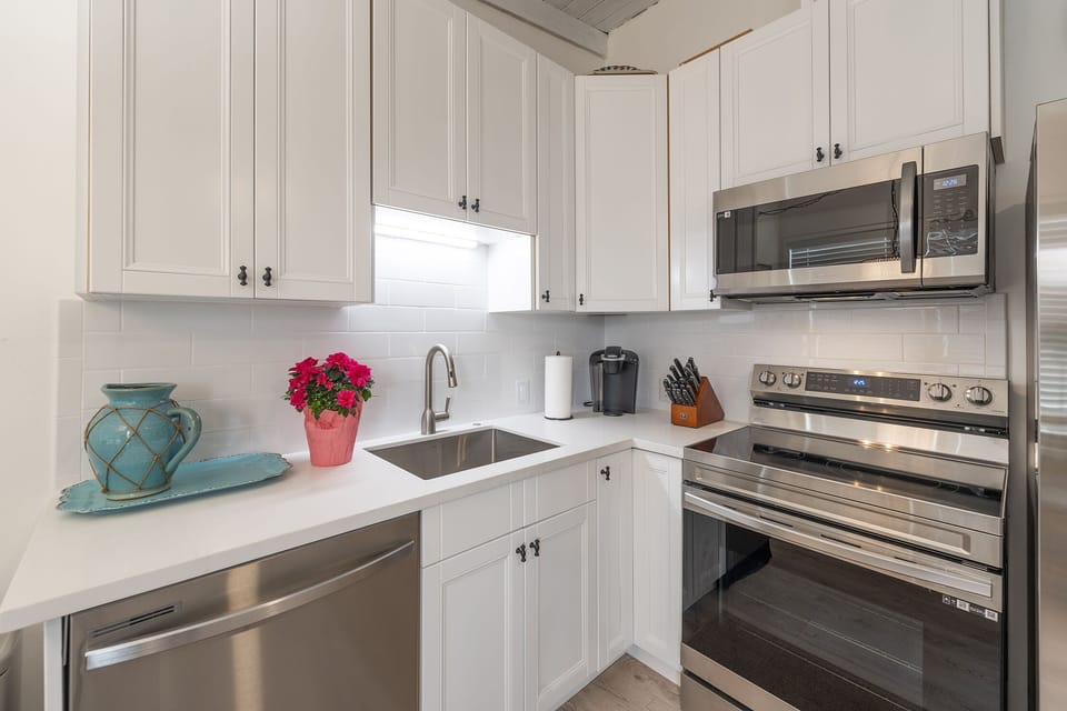 Remodeled kitchen boasts stainless appliances, upgraded cabinets & countertops.