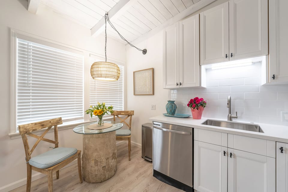Beach decor peaks with White hues, Rattan, chic accessories & a fresh kitchen.