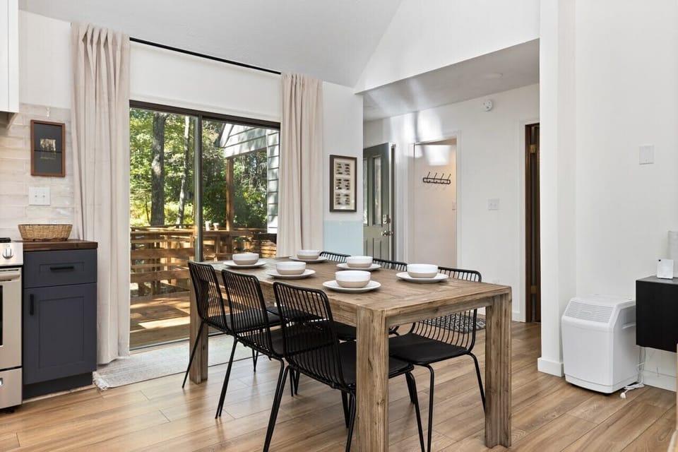 Indoor dining area opens to outdoor front porch and dining