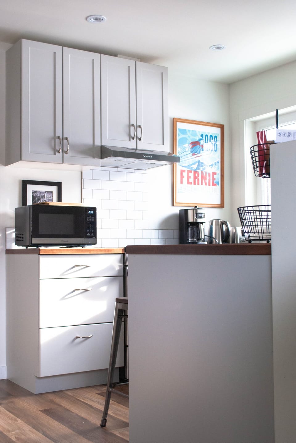 Kitchen has many amenities - dishes, cutlery, pots, small appliances .