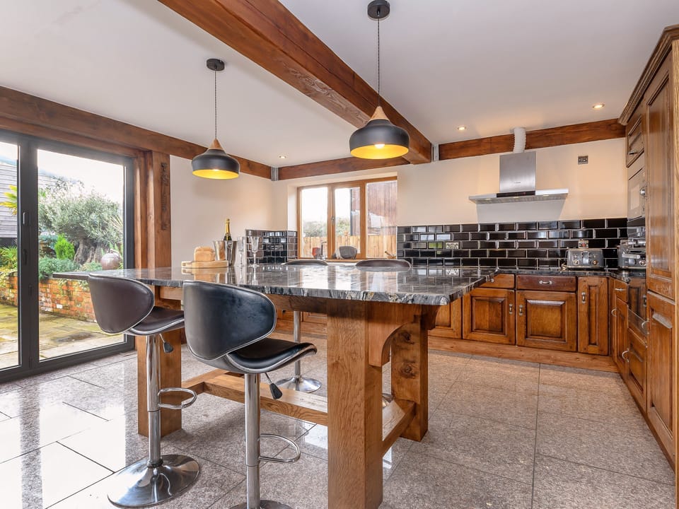 Light and airy kitchen with access to the rear patio and garden | Olive Lodge, Melbourne, near Derby