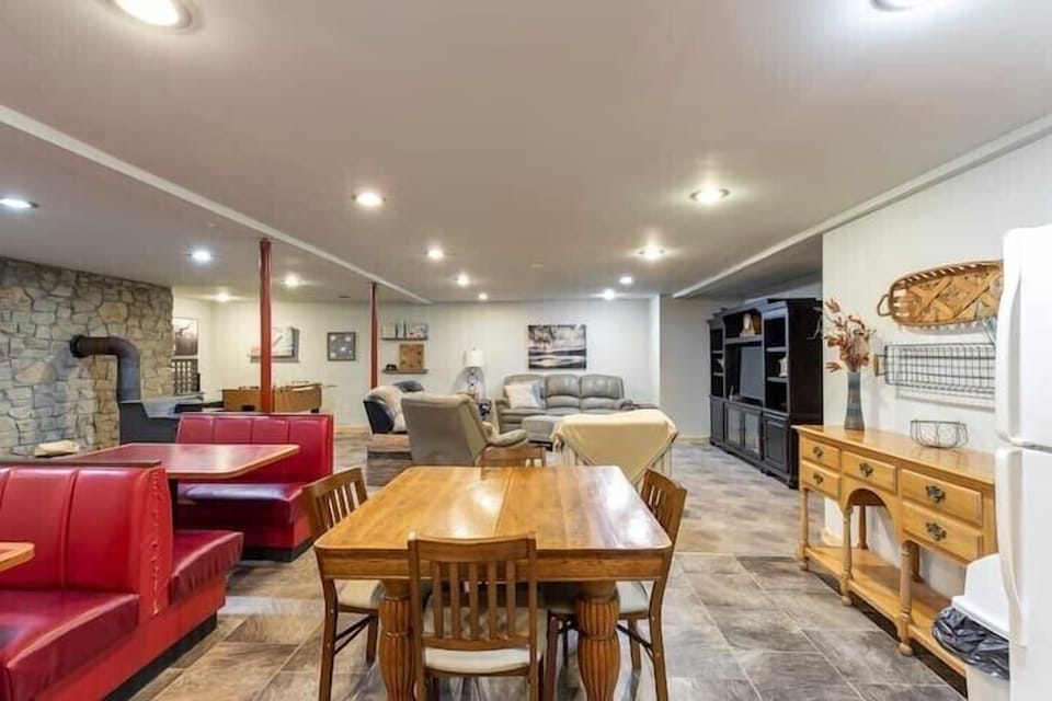 The basement living room/game area has booths and a table to seat 16