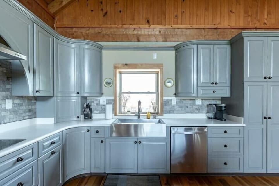 The upstairs kitchen overlooks the deck and backyard views.