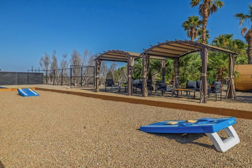 Chill & Challenge in the Desert Kick back in shaded comfort or spark some friendly competition with a game of cornhole — this desert hangout zone is built for laughs, lounging, and laid-back vibes. Game on, then lounge on!
