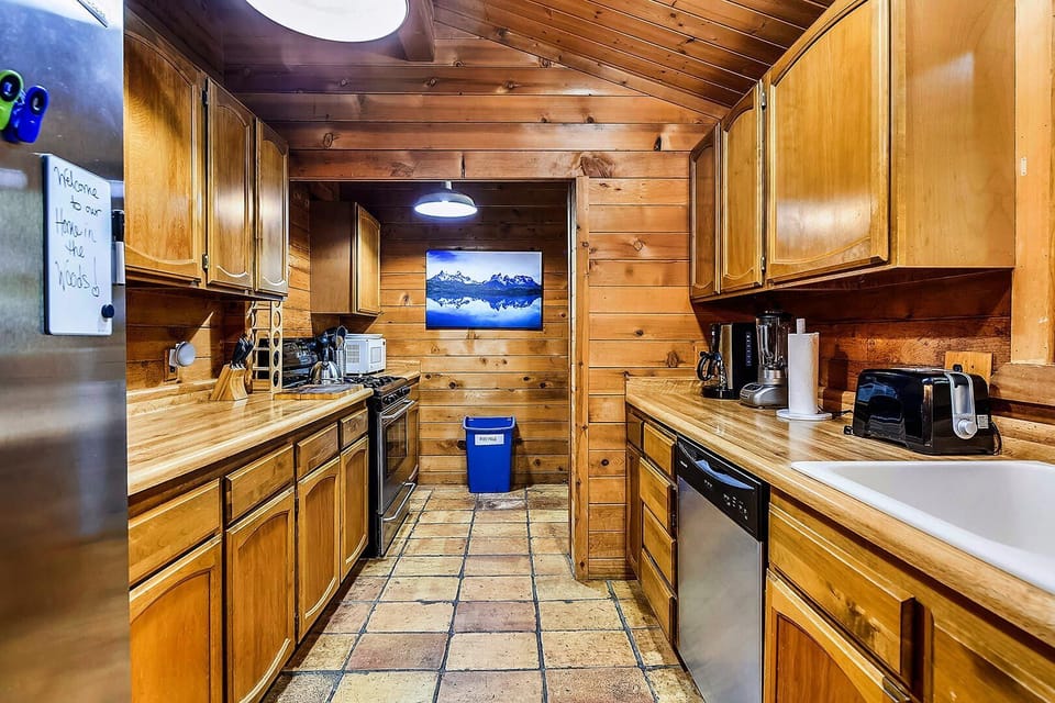 A full kitchen with stainless steel appliances.
