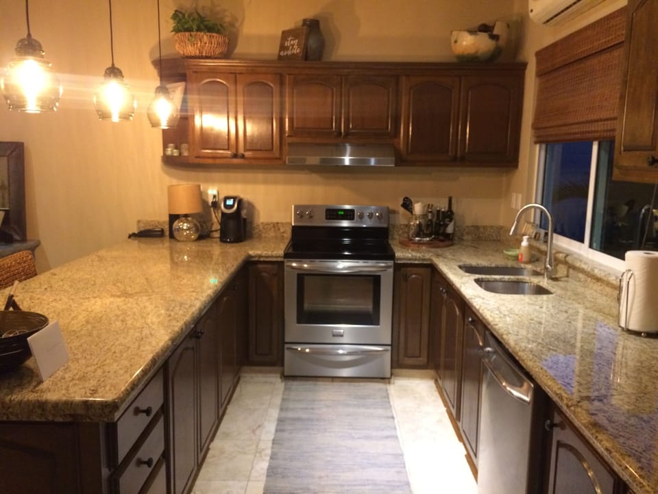 Fully stocked kitchen with stainless steel appliances.